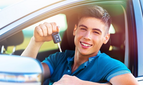 Young Guy in car holding keys